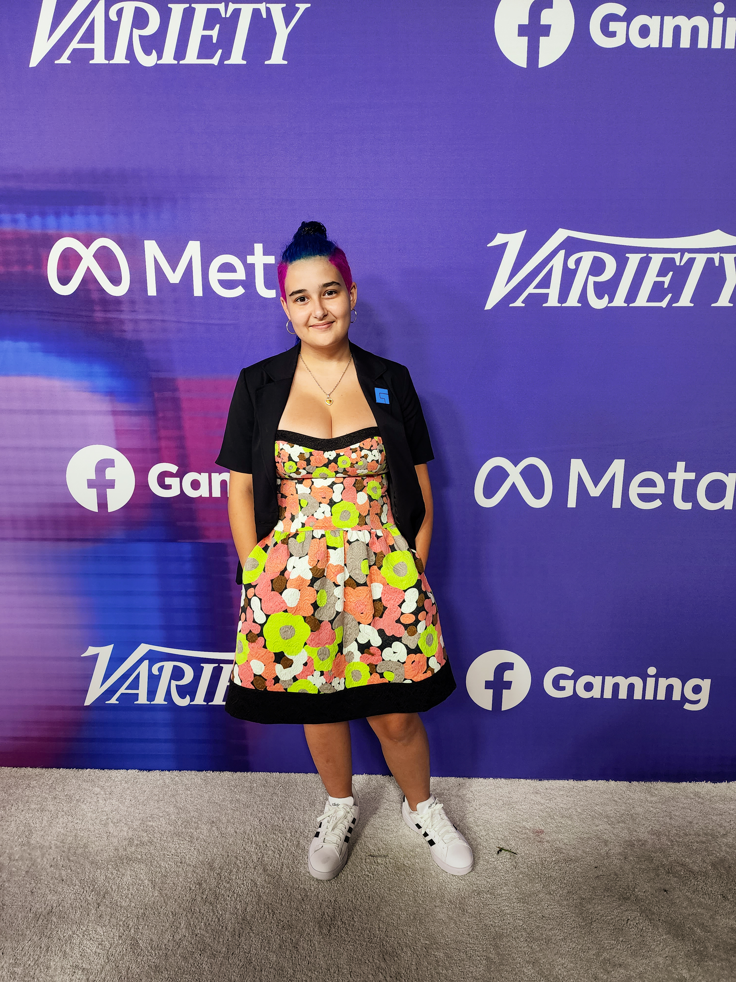 Fabu standing in front of a Meta and Facebook Gaming event backdrop