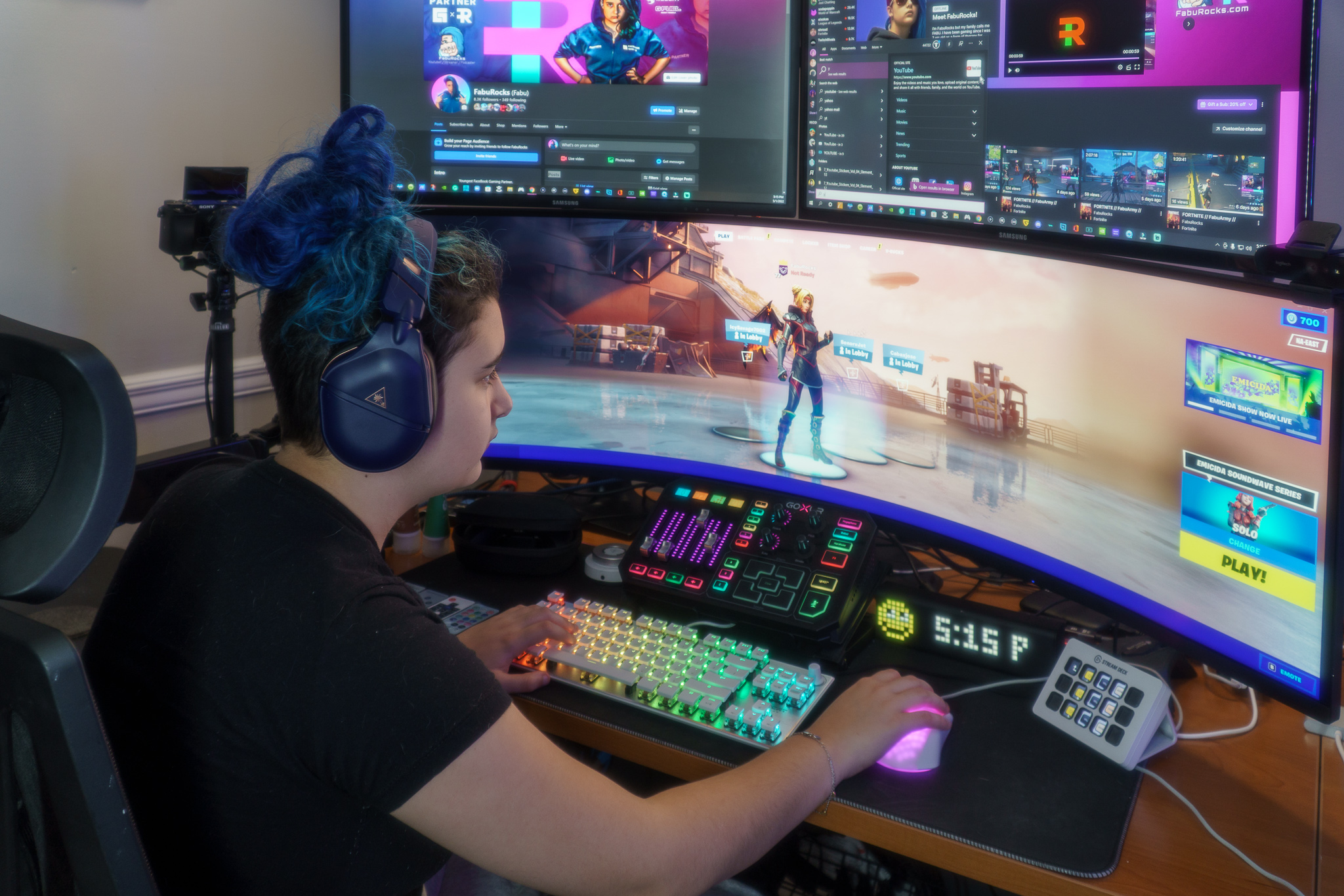 Fabu gaming at her livestream setup with creator screens around her