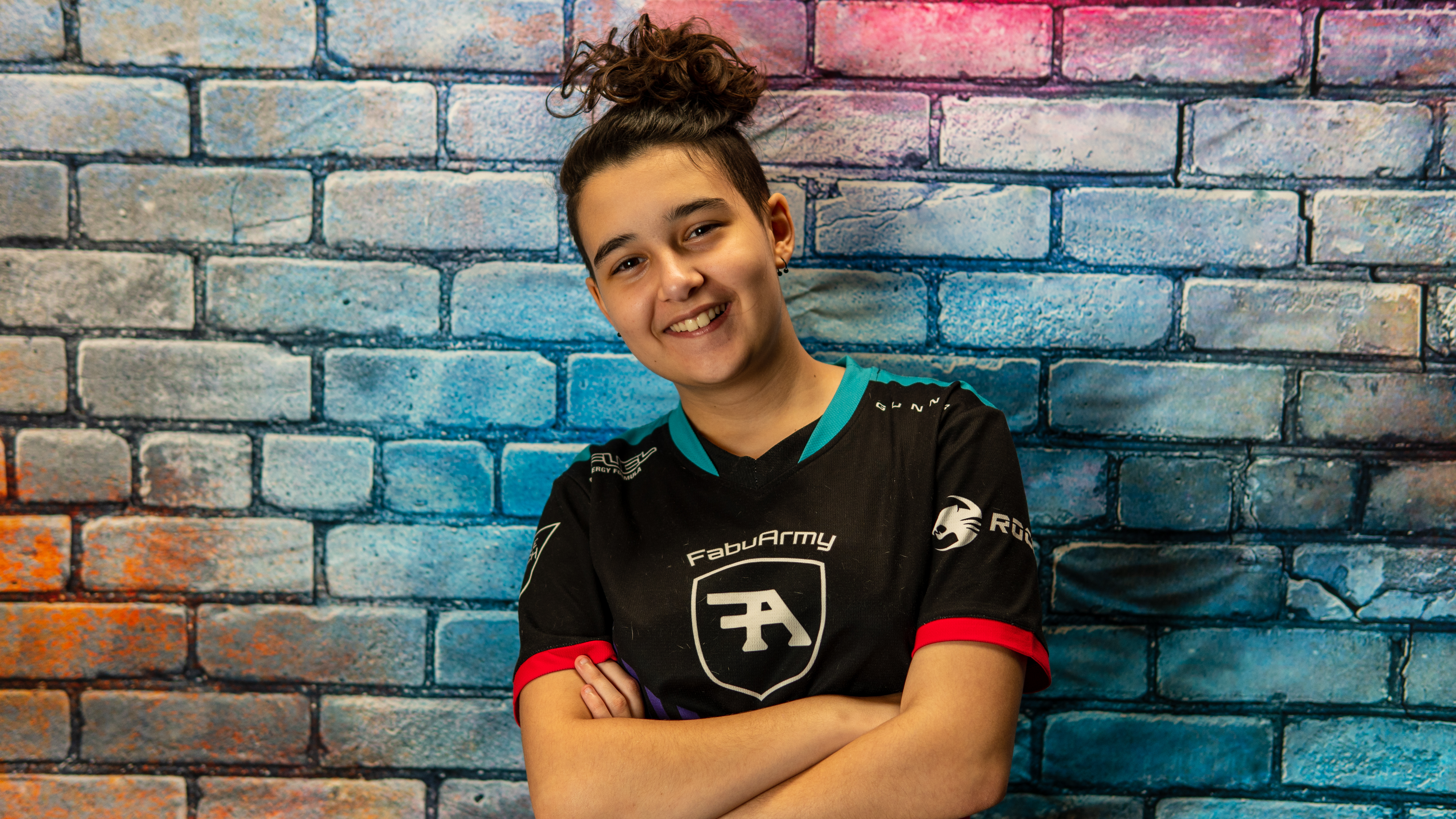 Fabu smiling in a FabuArmy jersey in front of the brand portrait wall